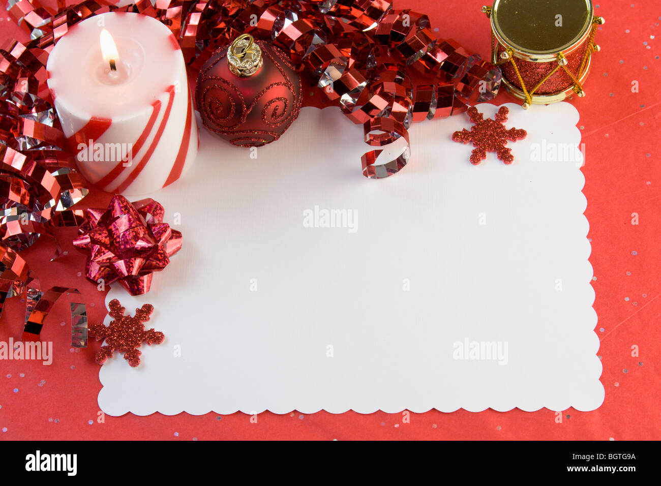 blank Christmas card with Red ribbon, bauble, snowflakes, candle and copyspace Stock Photo
