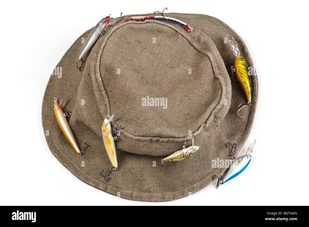 A fisherman's hat with lures attached shot against white