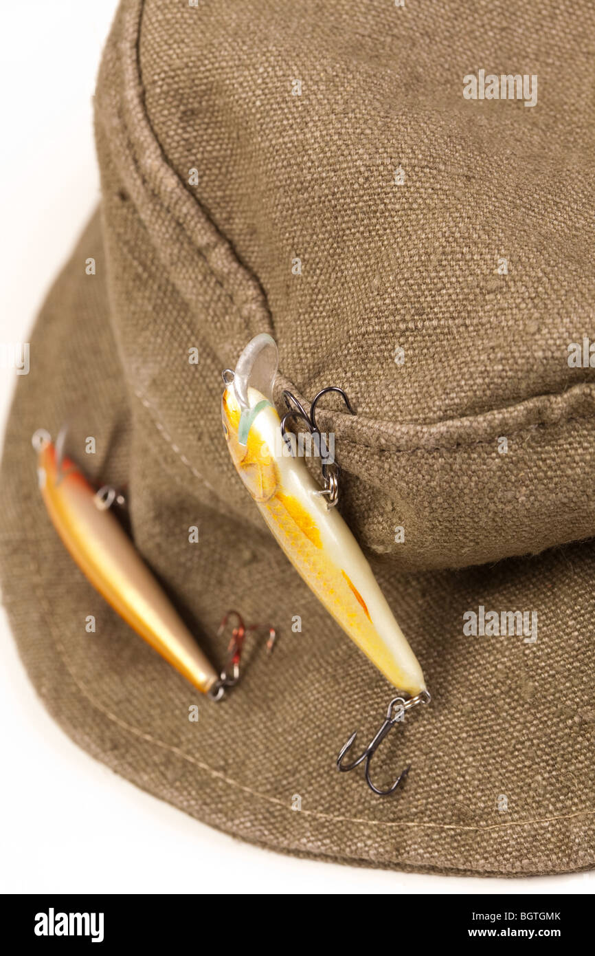 A fisherman's hat with lures attached shot against white background with  soft shadow Stock Photo - Alamy