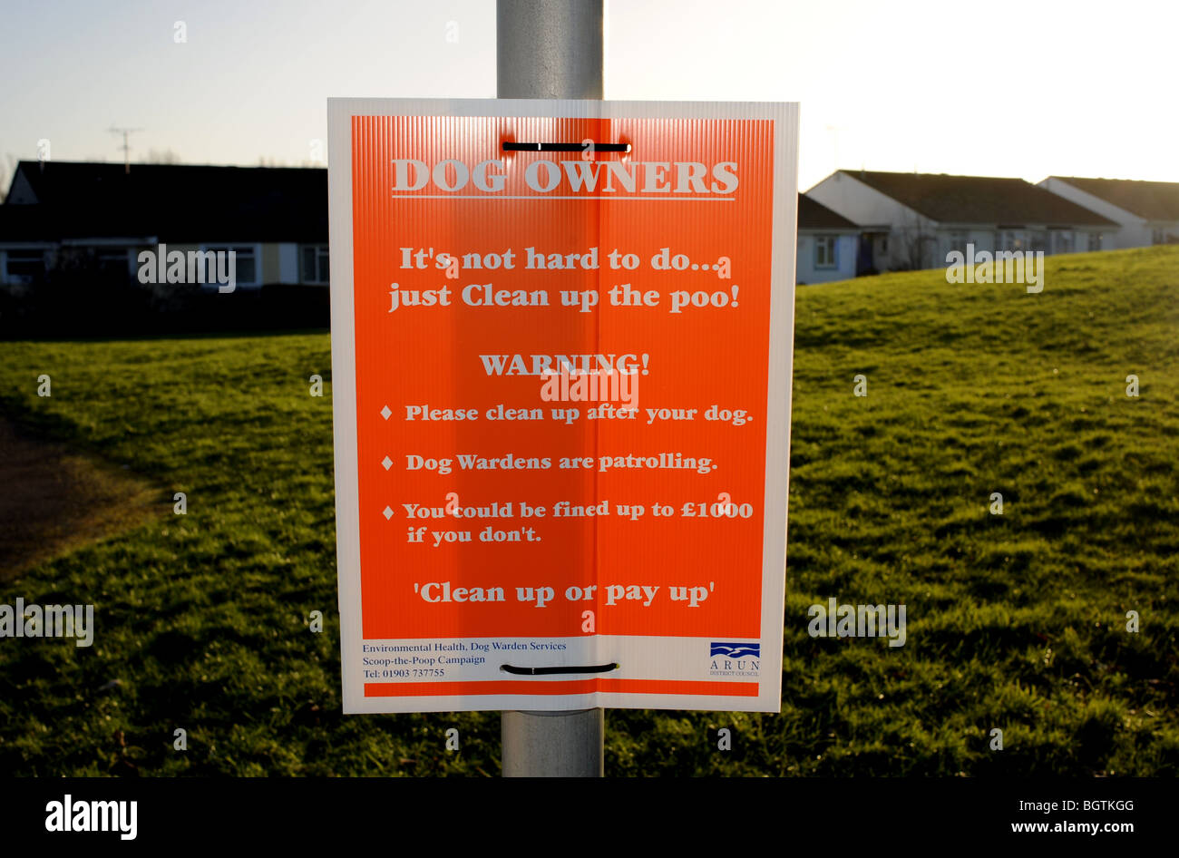 Arun Council sign asking dog owners to clean up dog mess Littlehampton UK Stock Photo