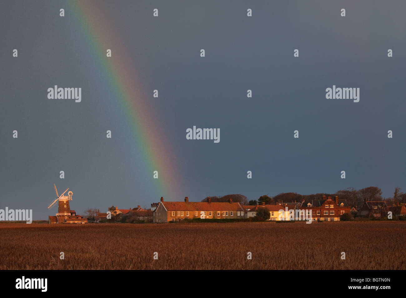 Rainbow over Cley Village and Windmill on the North Norfolk Coast Stock Photo