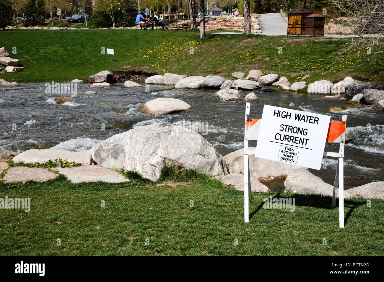 Warning notice about high water and strong current stating 'Turn around, don't drown' at Blue River, Breckenridge, Colorado USA Stock Photo