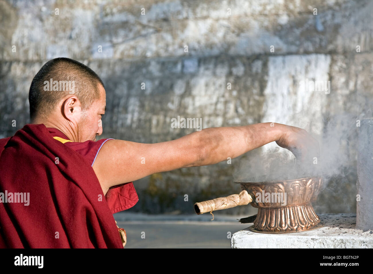 Buddhist monk burning incense. McLeod Ganj. Dharamsala. India Stock