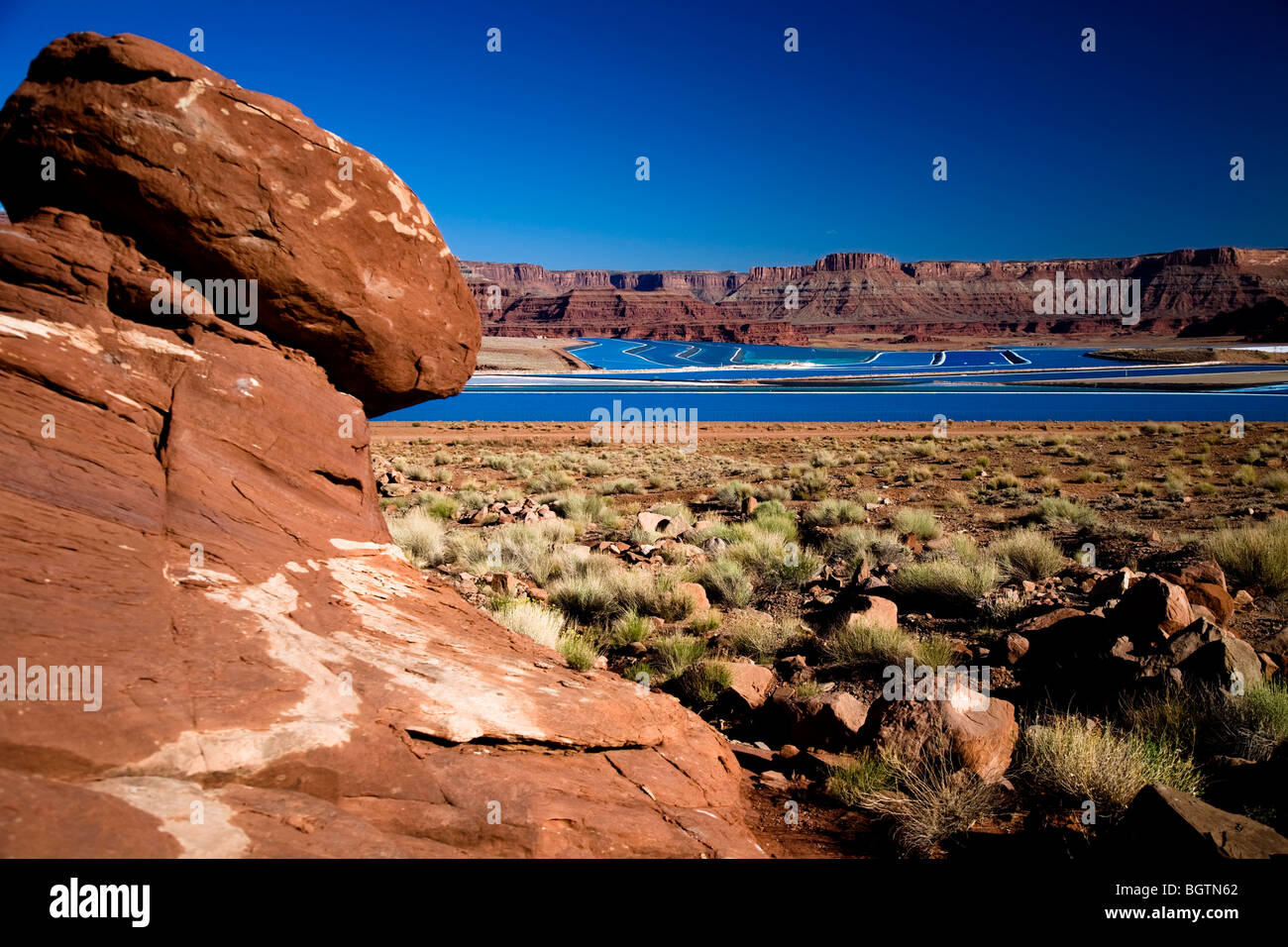 Scene overlooking the bight blue Cane Creek potash mine water evaporation ponds near Moab, Utah, USA Stock Photo
