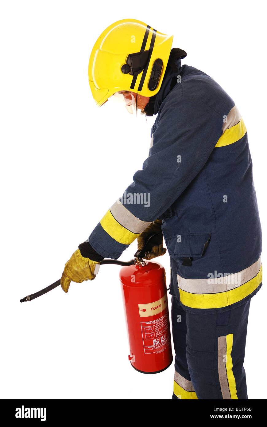 Firefighter using extinguisher Stock Photo Alamy