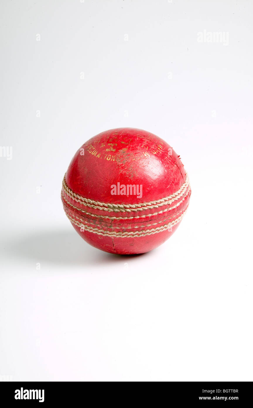 Bright red cricket ball on grey background Stock Photo