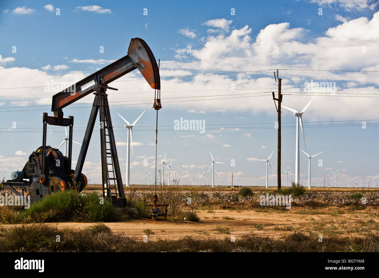 Old energy is still pulled from the earth, while new energy from the wind is harnessed in west Texas. Stock Photo