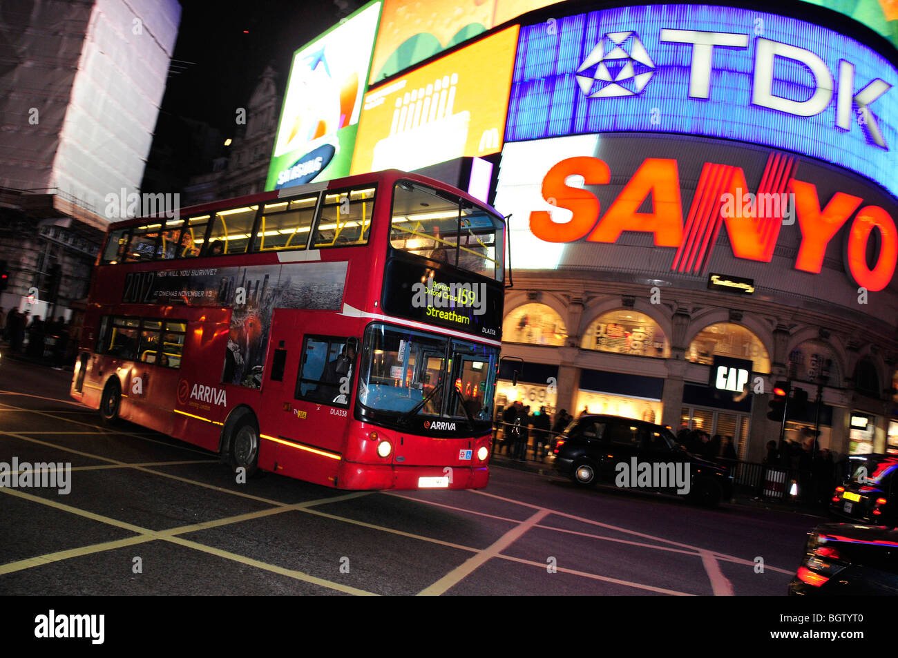 Red double-decker bus in front of the neon sign at Piccadilly Circus, London, England, United Kingdom, Europe Stock Photo