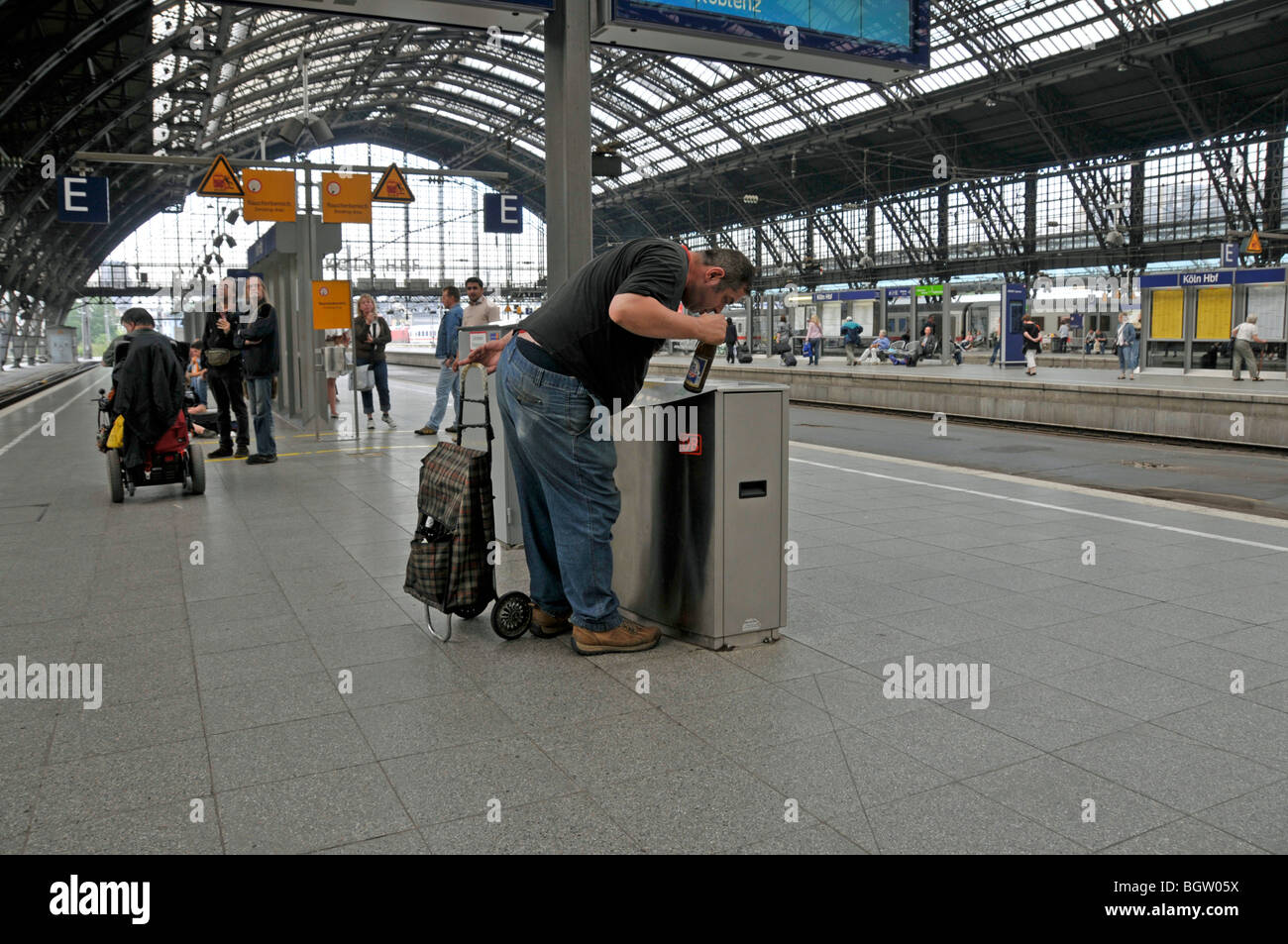 Man collecting deposit bottles in the main station in Cologne, North Rhine-Westphalia, Germany, Europe Stock Photo