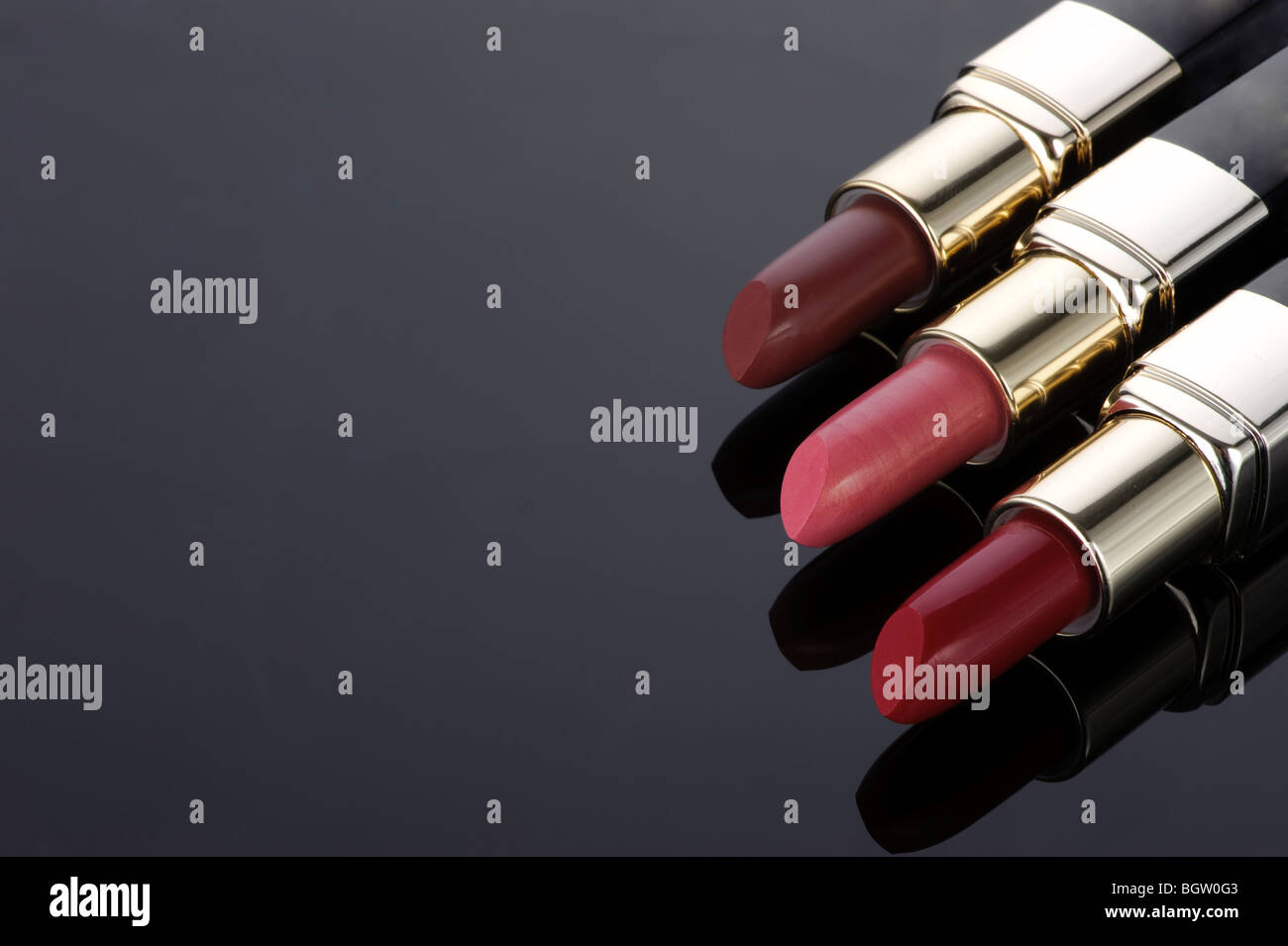 three lipsticks on a black background Stock Photo