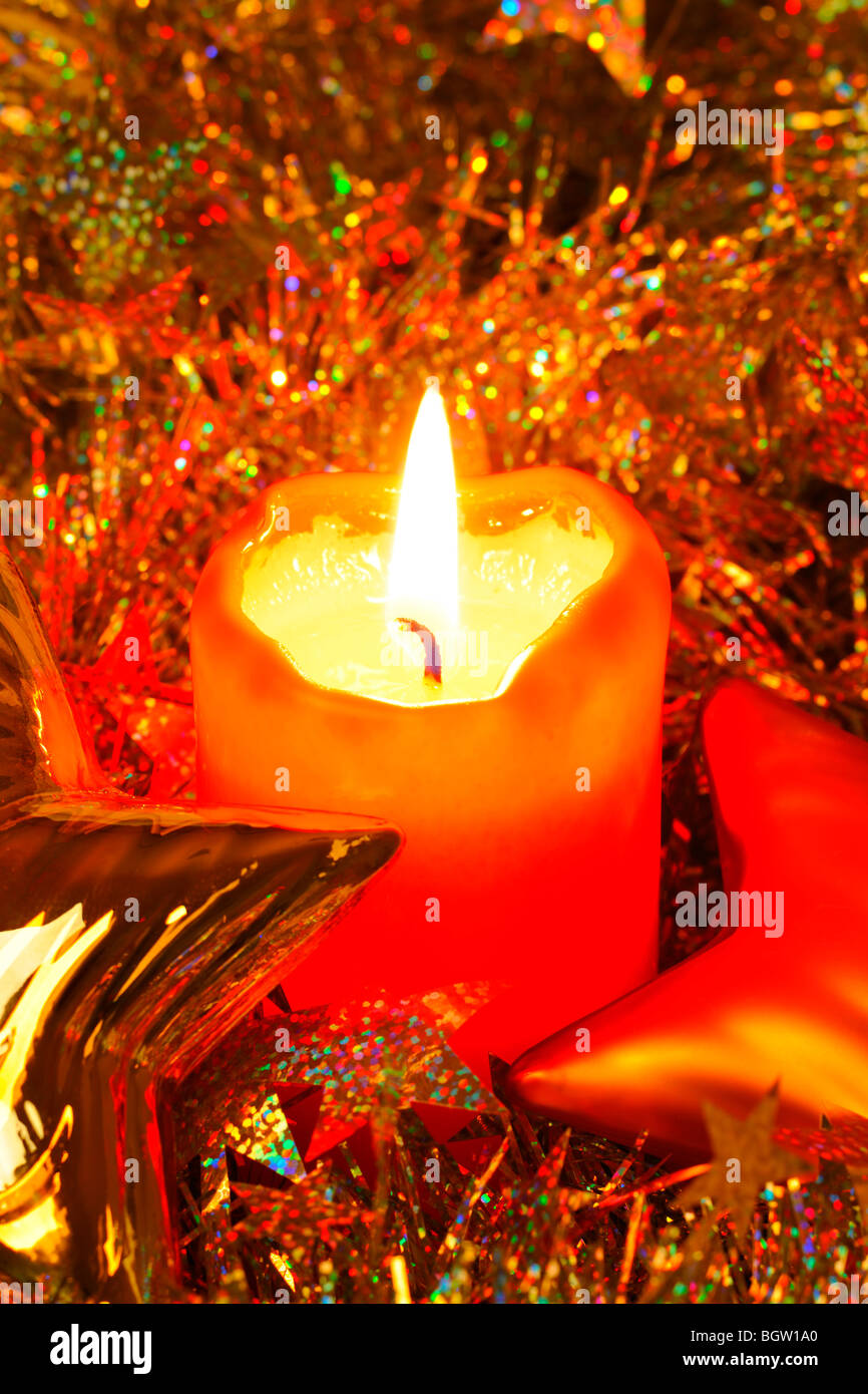 Burning red candle, Christmas decorations Stock Photo Alamy