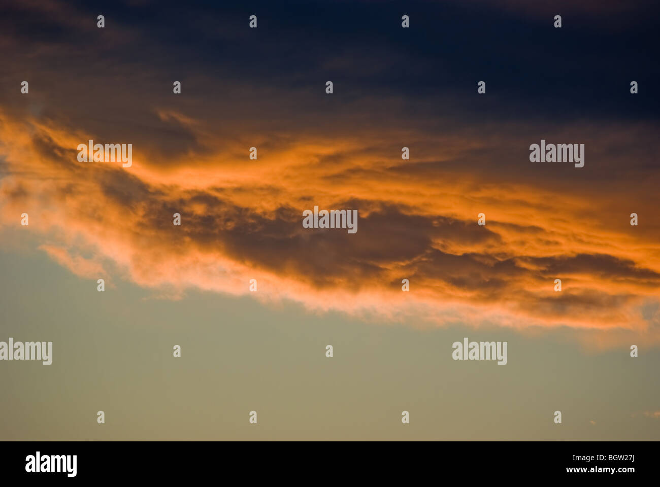 Sunset-lit thunderstorm cell bottom Stock Photo