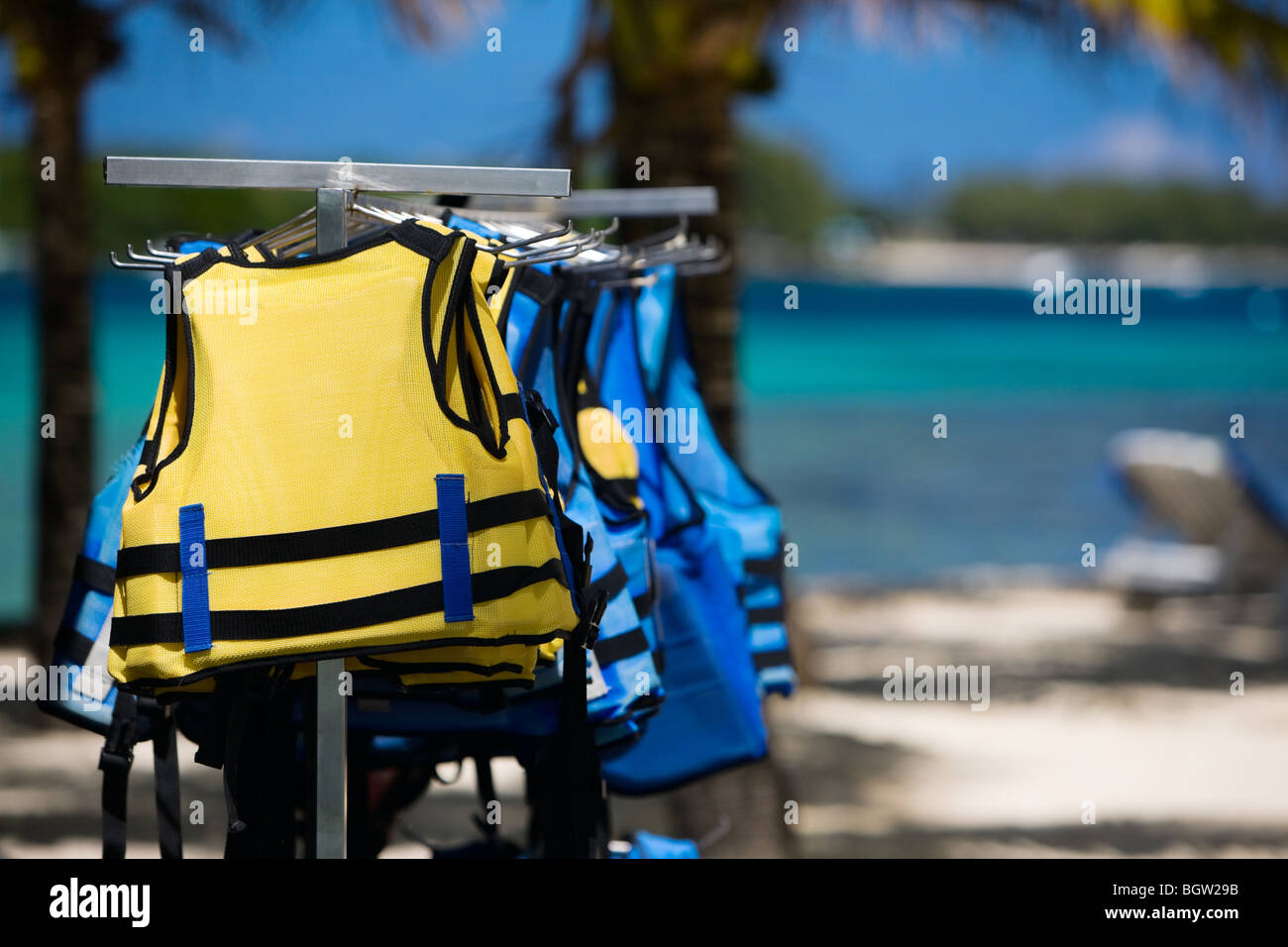 Yellow and blue life jackets on the beach Stock Photo
