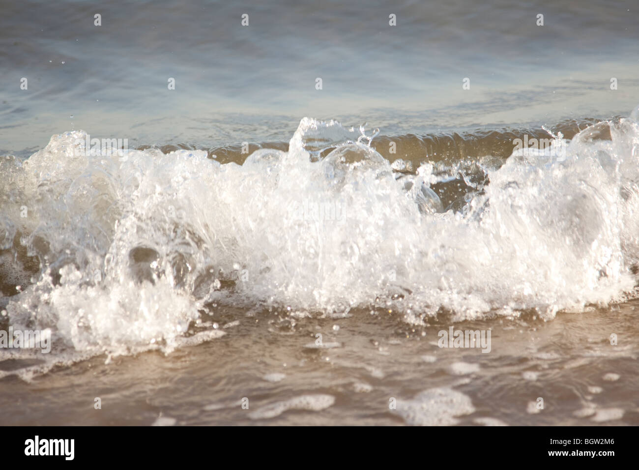 Gentle surf lapping against a golden shore Stock Photo Alamy