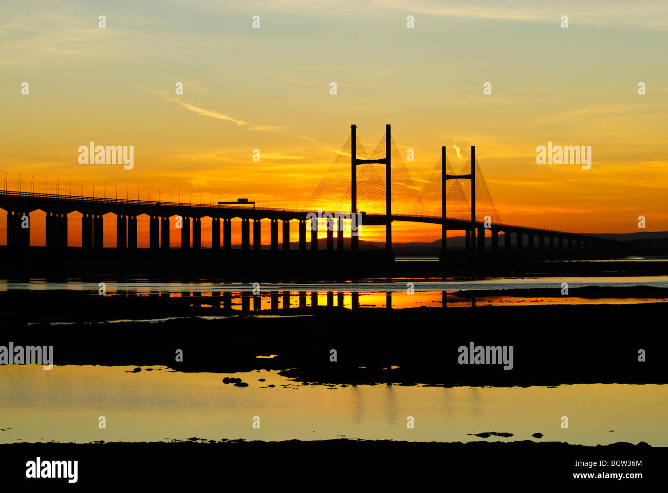 Second Severn crossing in silhouette with the sun setting behind it at dusk Stock Photo
