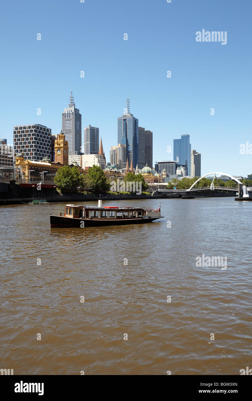 A river cruise boat on the Yarra river with a city view, Melbourne, Victoria, Australia Stock Photo