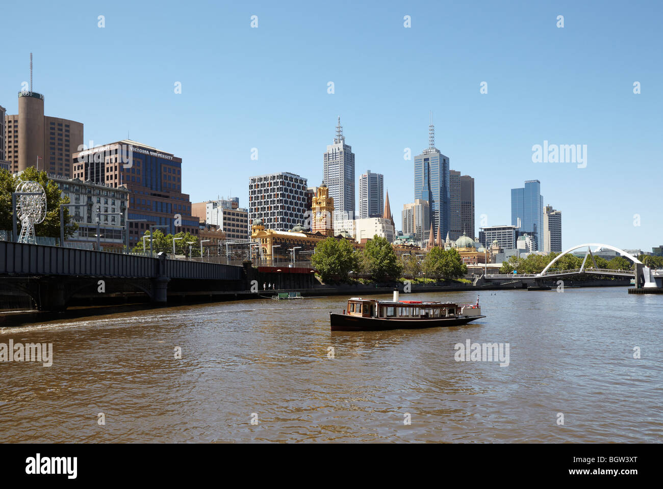 A river cruise boat on the Yarra river with a city view, Melbourne, Victoria, Australia Stock Photo