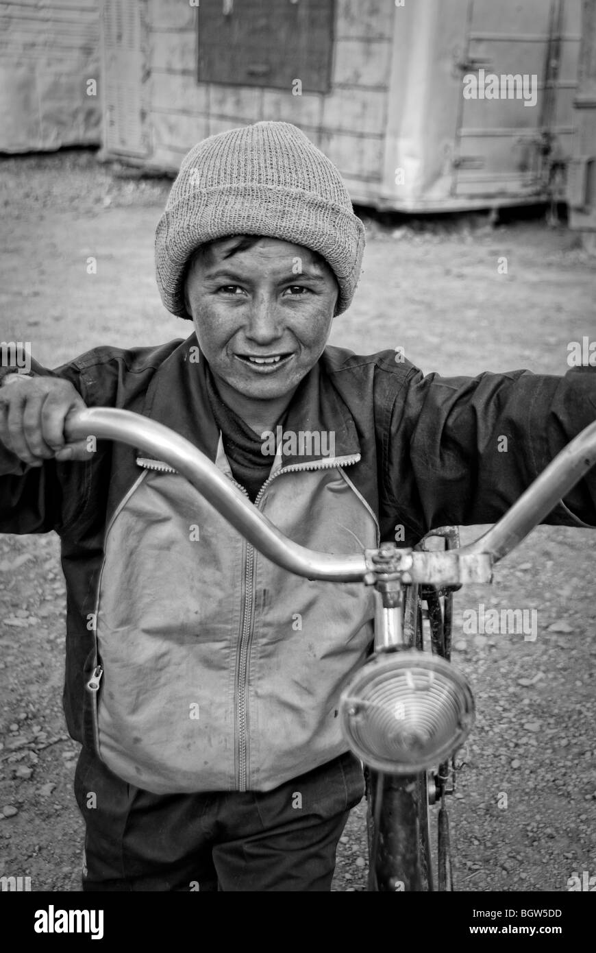 Portrait of a young boy with his bike, Murgab, Tajikistan Stock Photo