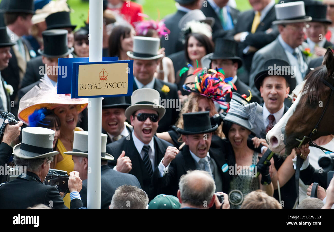 Racegoers cheering a winning horse at Royal Ascot Stock Photo