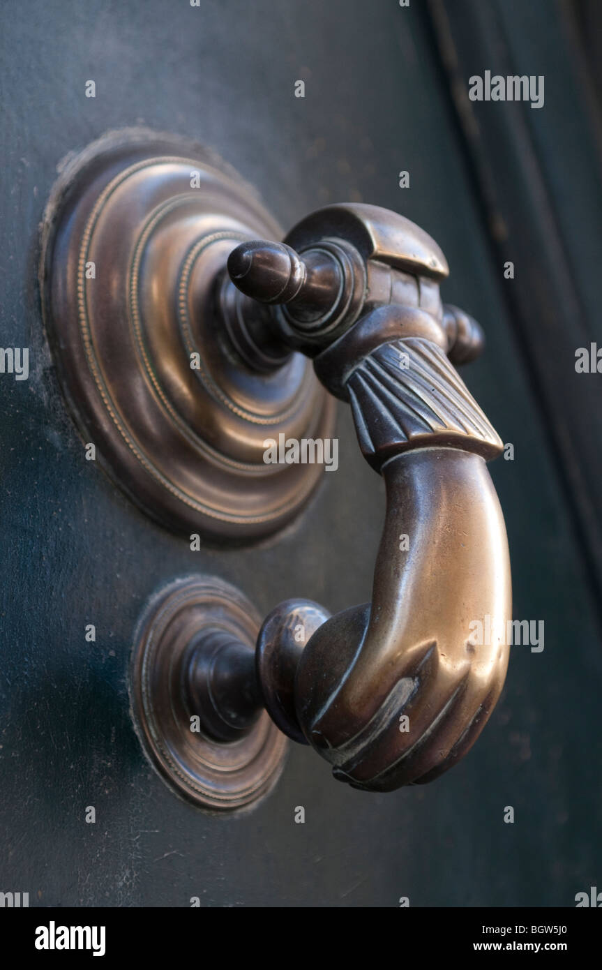 Door knocker in the shape of a hand, Sauve, Gard, South of France Stock Photo