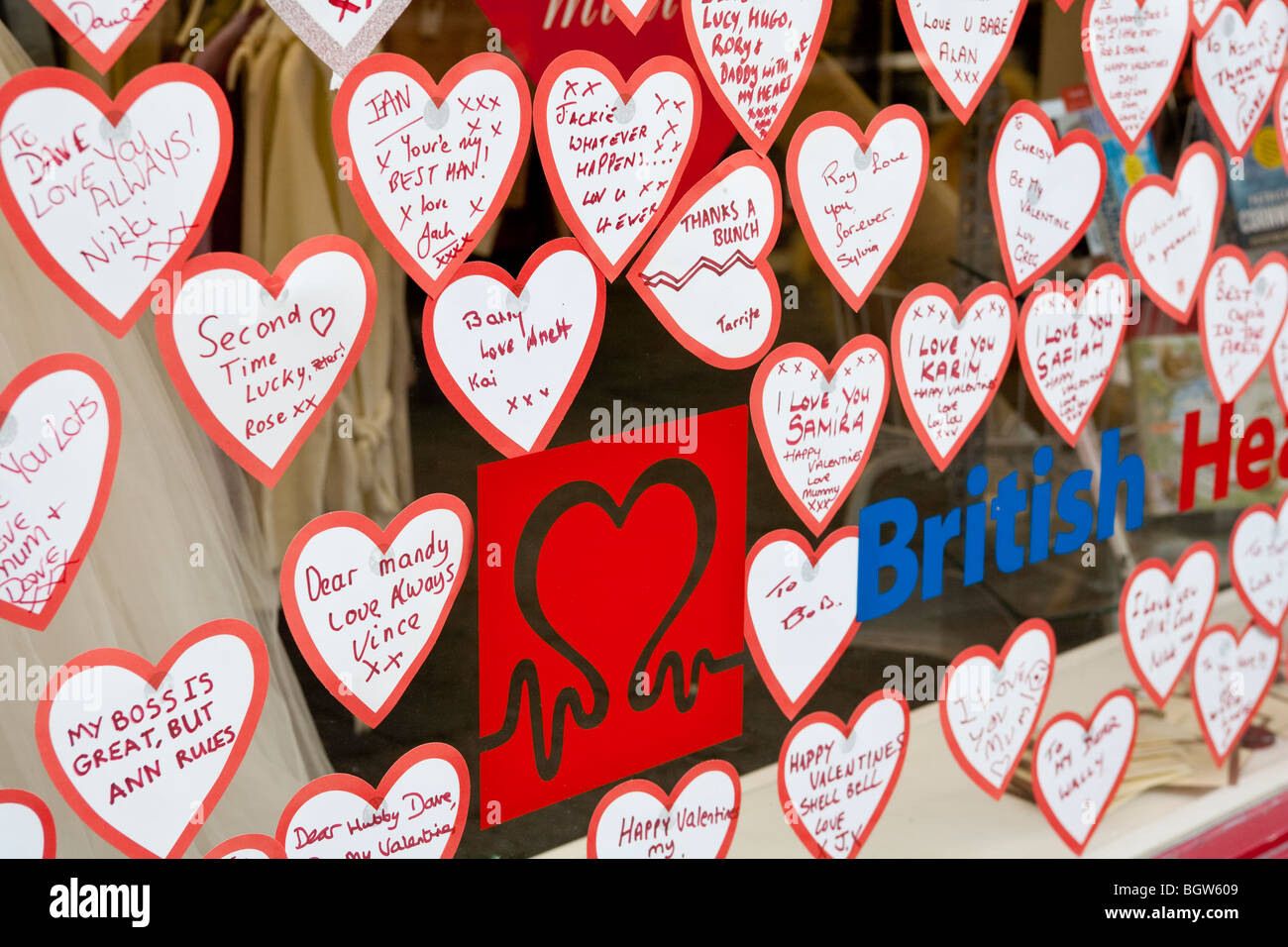 Messages on paper hearts in window of British Heart Foundation charity shop  for Valentines Day Stock Photo - Alamy