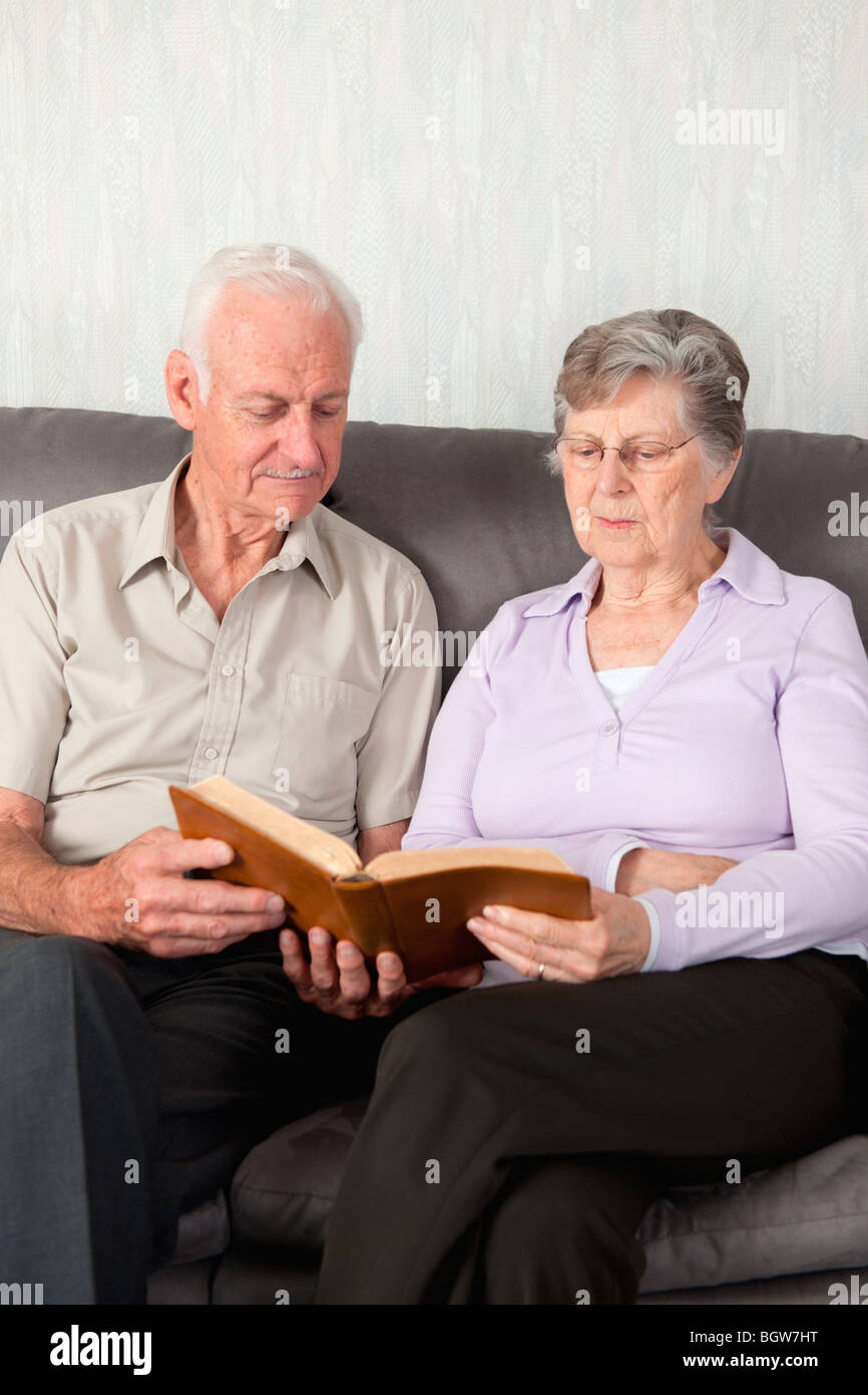 An elderly couple having worship with the Bible Stock Photo
