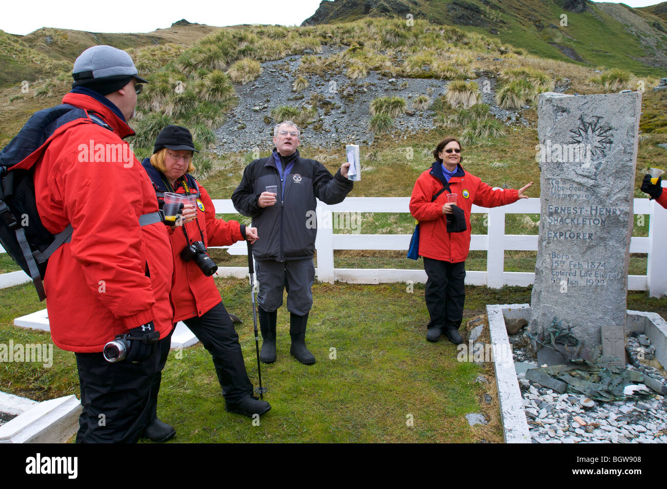 Adventurer Trevor Potts, toasting "The Boss", Sir Ernest Shackleton at his gravesite, Grytviken, Soth Georgia Island. Stock Photo