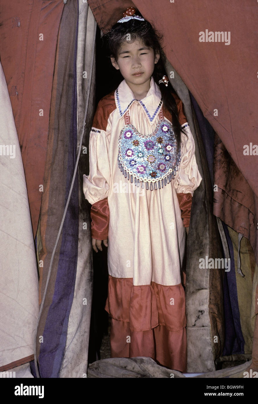 A young Xakac girl stands in the doorway of her yurt during the annual Mongolian People's Festival south of Abakan, Siberia. Stock Photo