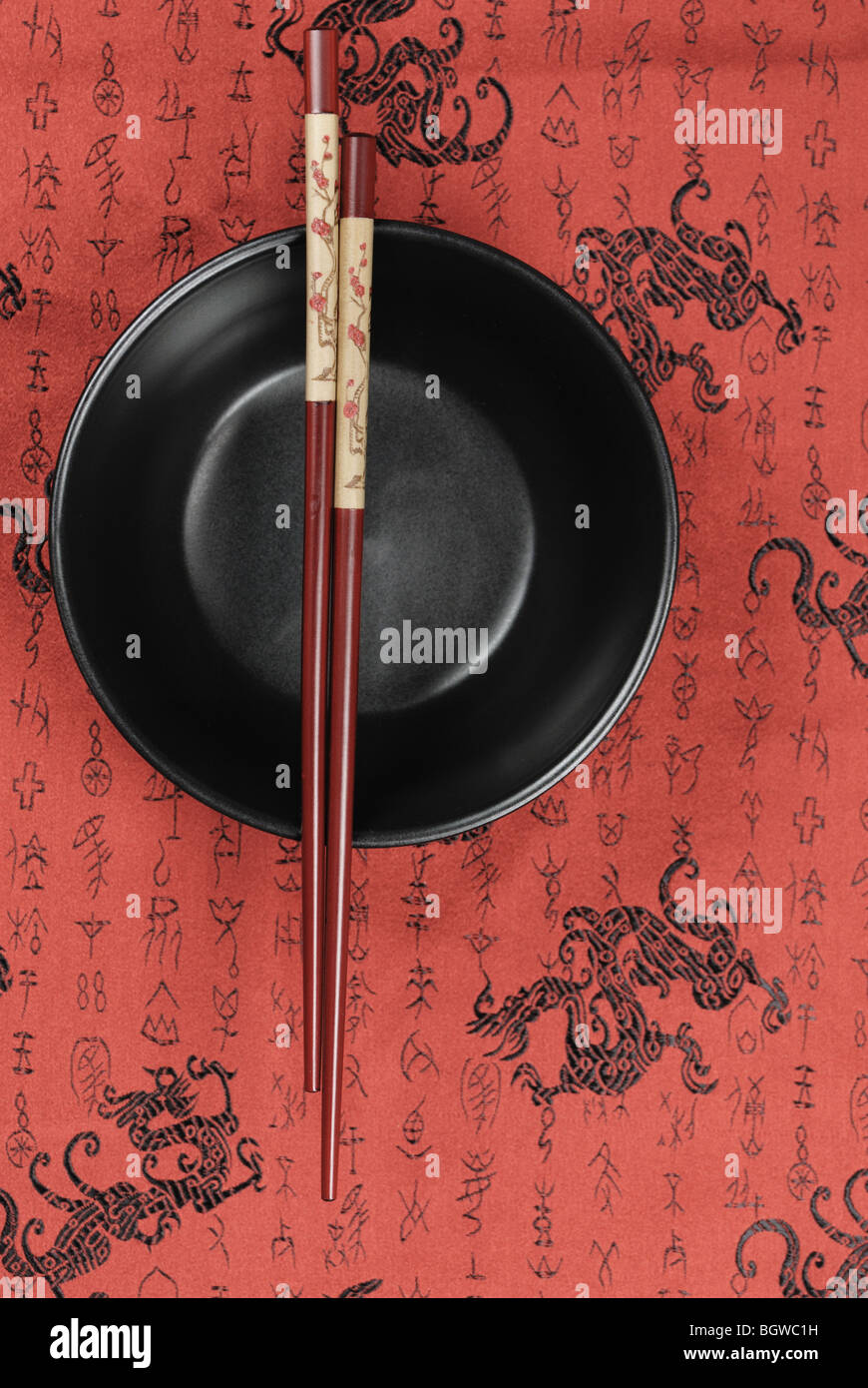 Oriental ceramic bowl and chopsticks on traditional auspicious background. Stock Photo