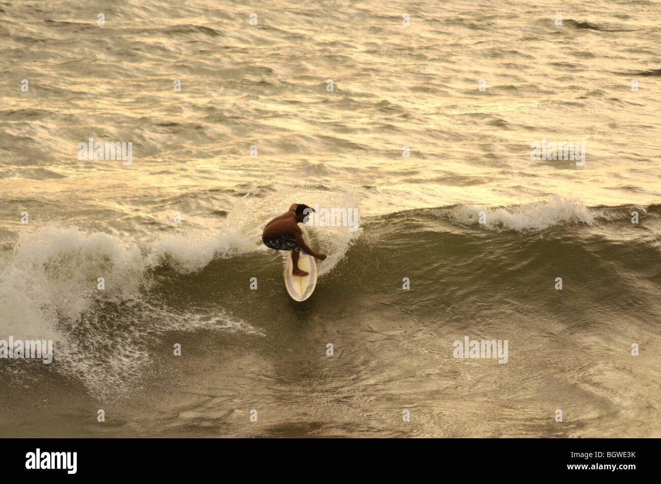 Surfing is a popular sport in Bali Island Stock Photo