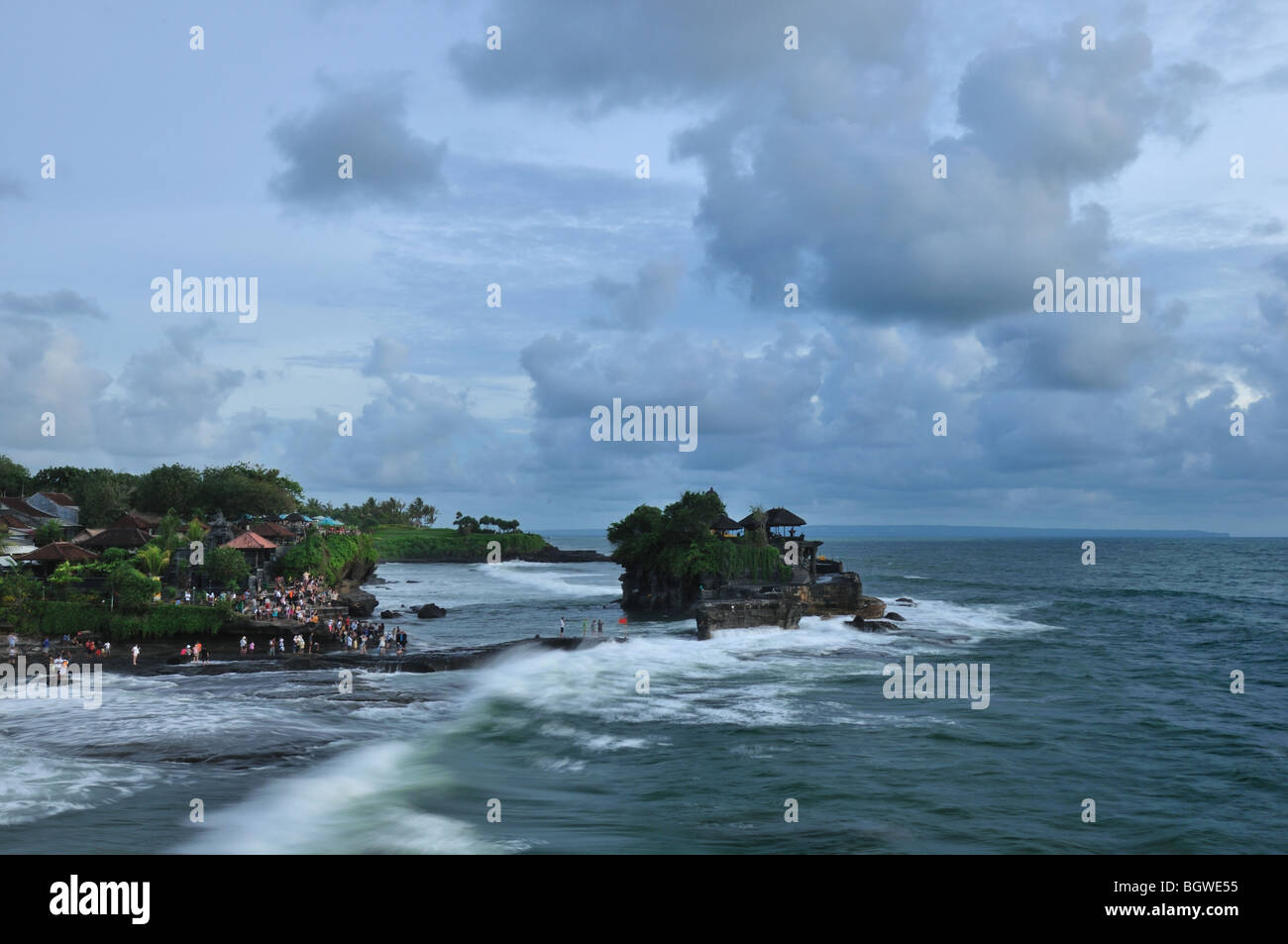 A Hindu temple in an island only when low tide then the worshiper can go there an pray. It is called Pura Tanah Lot Stock Photo