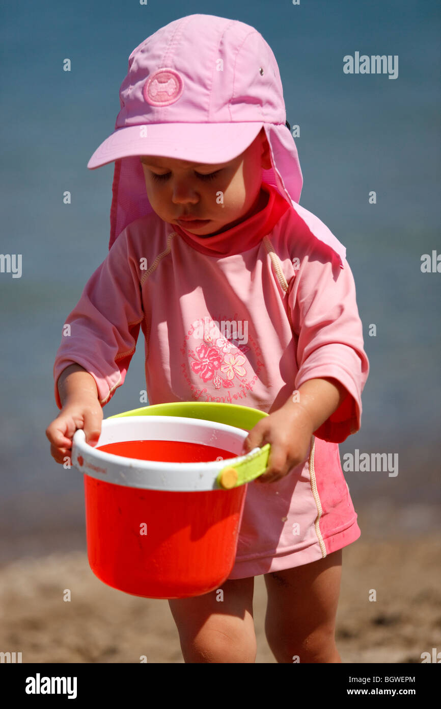 girl playing with bucket on beach Stock Photo Alamy