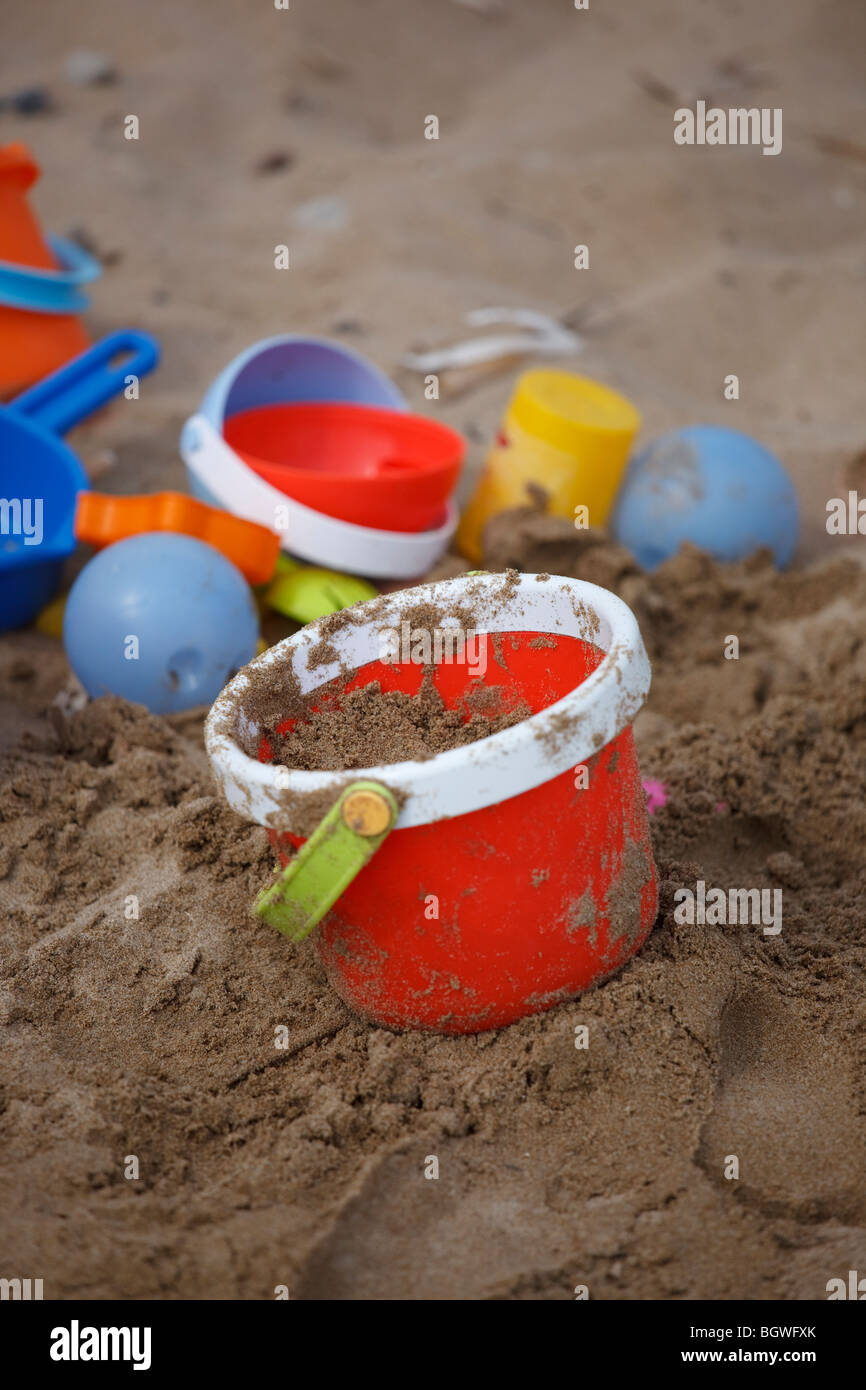colorful plastic buckets on the beach Stock Photo Alamy