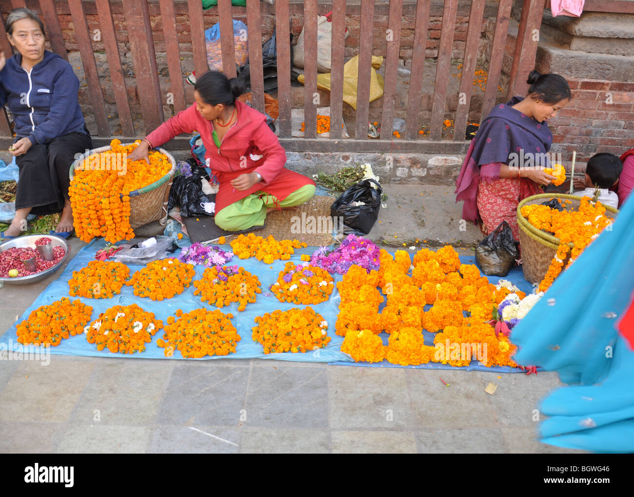 Woman Street Trader Selling Marigolds Other Flowers From A Sheet On The Street Near Durbar 