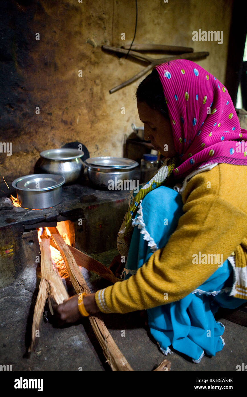 Woman boiling water at home in southern India Stock Photo