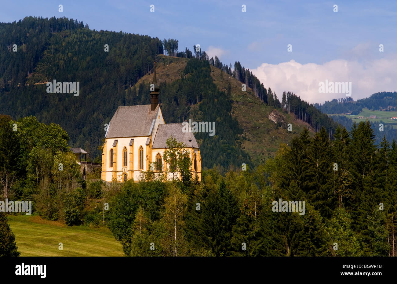 Old historical old church called Parish Church of Murau Austria and mountains Stock Photo