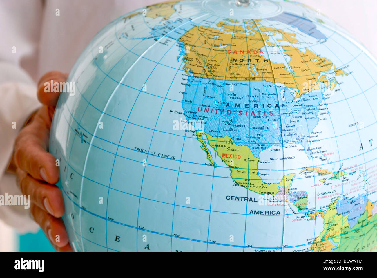 Man holding a globe in his hand Stock Photo - Alamy