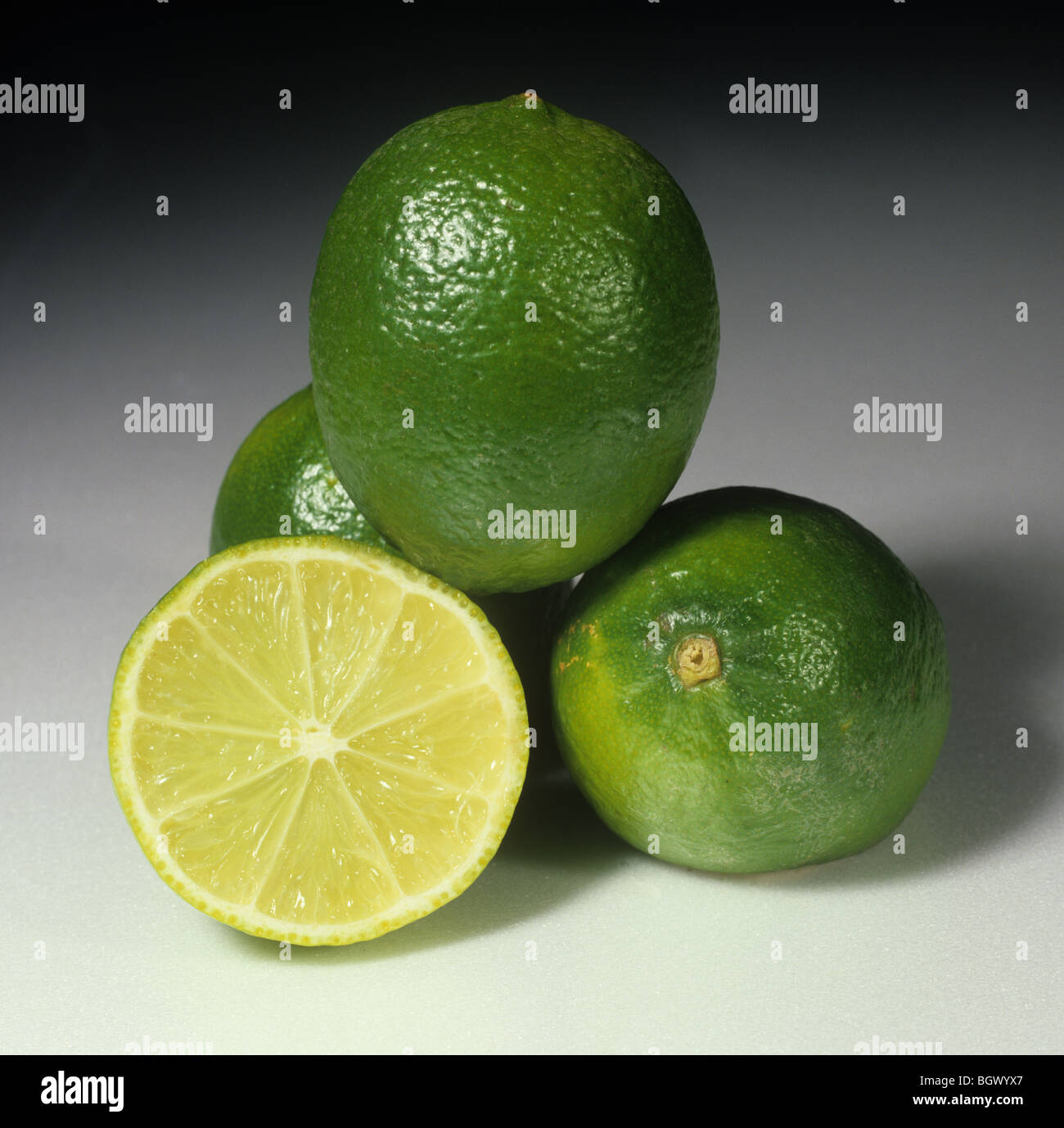 Whole & sectioned lime fruit varieties Tahiti & Persian, country of origin: Brazil Stock Photo