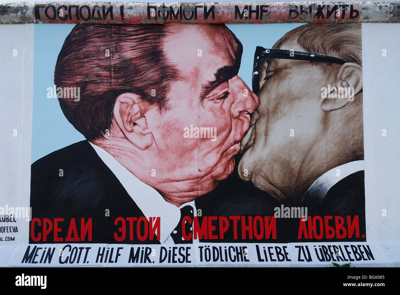 Berlin. Germany. The East Side Gallery. Caricature of Leonid Brezhnev & Erich Honecker kissing by artist Dmitri Vrubel. Stock Photo