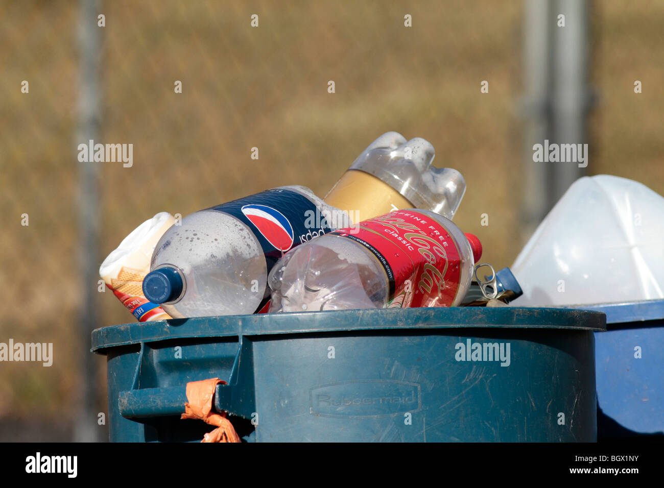 A recycling bin can barrel overflowing with plastic soda bottles Stock Photo Alamy