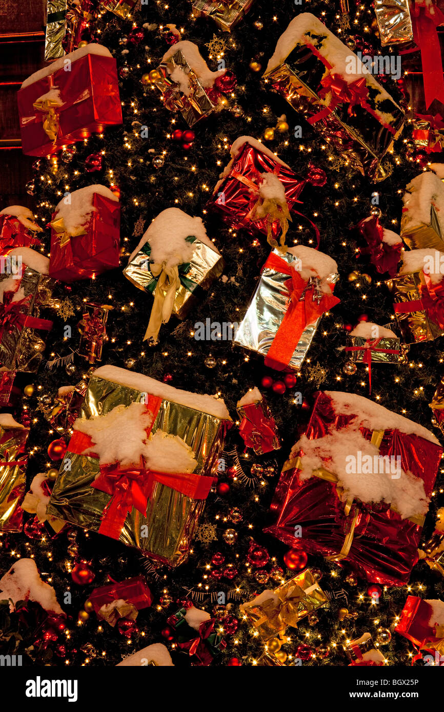 Colourful Christmas Tree with lights and presents and real snow