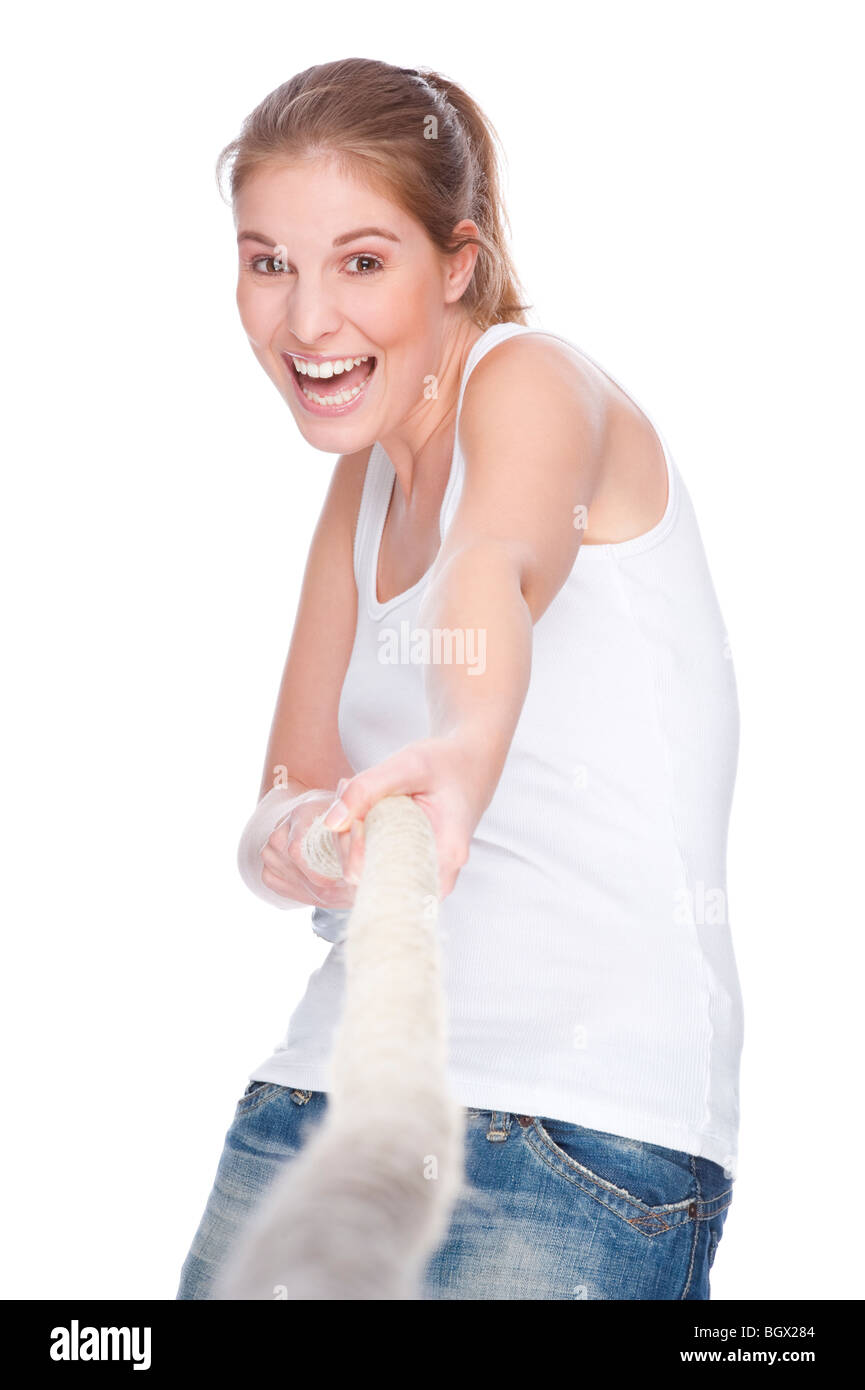 Full isolated studio picture from a young and beautiful woman doing tug of war Stock Photo