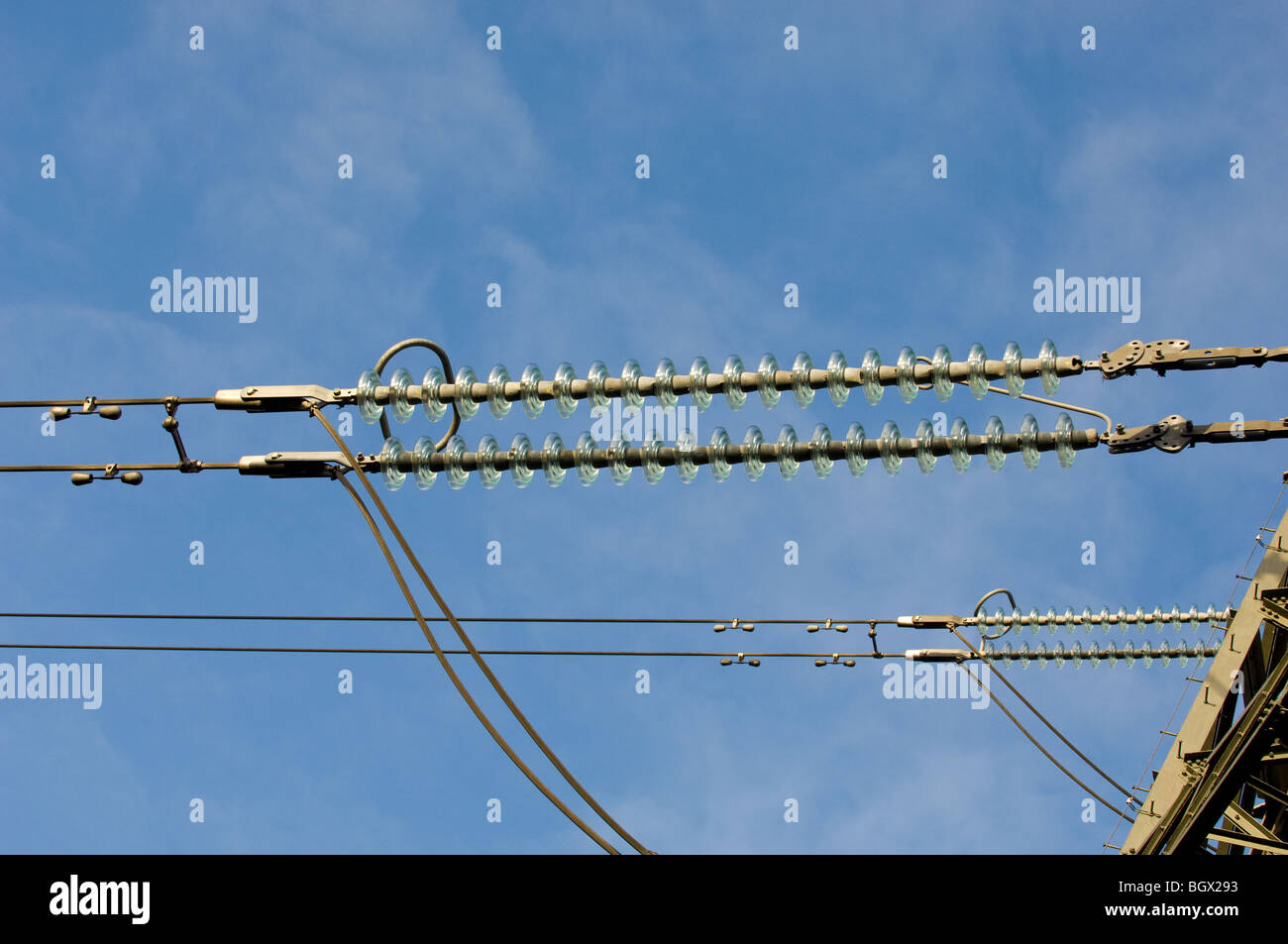 High voltage overhead cables transmission lines operating at 275kV with glass insulators. Stock Photo