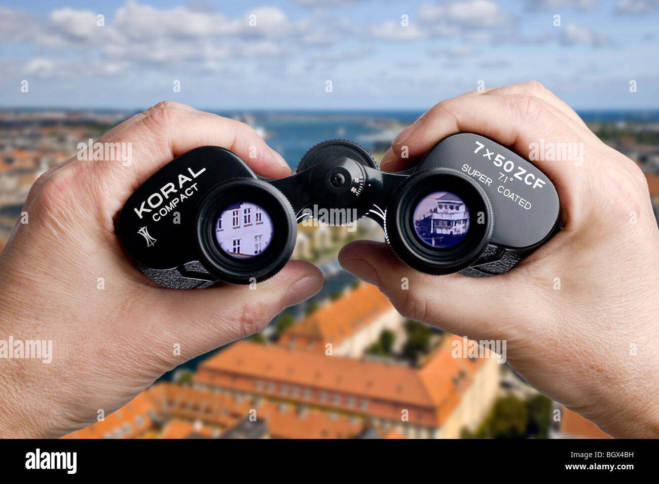 Looking through binoculars toward the harbour Stock Photo Alamy