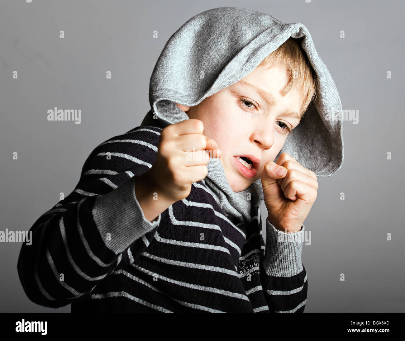 a young blonde street child fights for survival Stock Photo