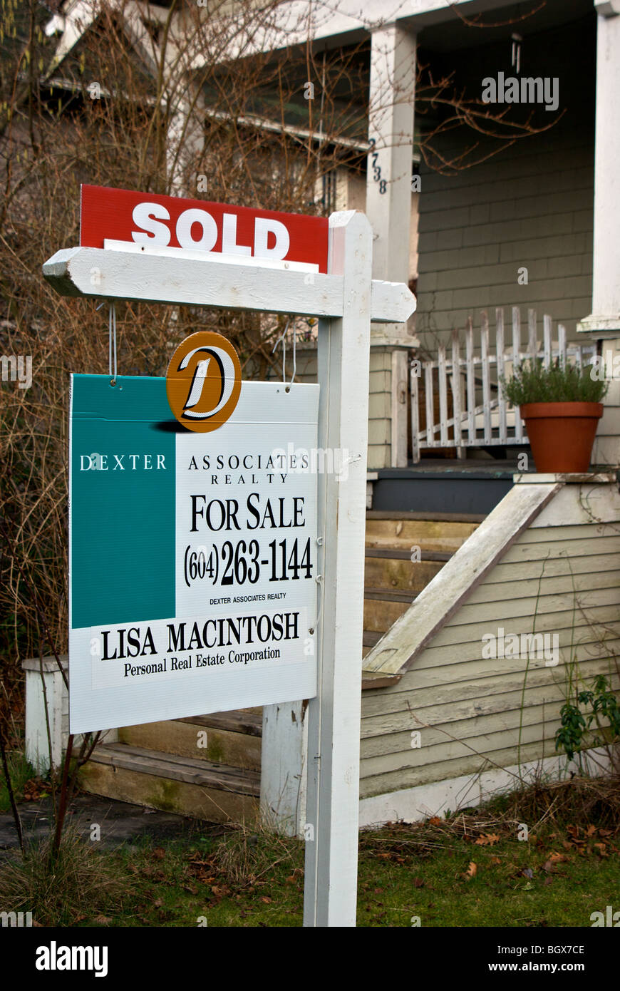 Real estate for sale sign in hot Vancouver housing market old house sold slated for demolition Stock Photo