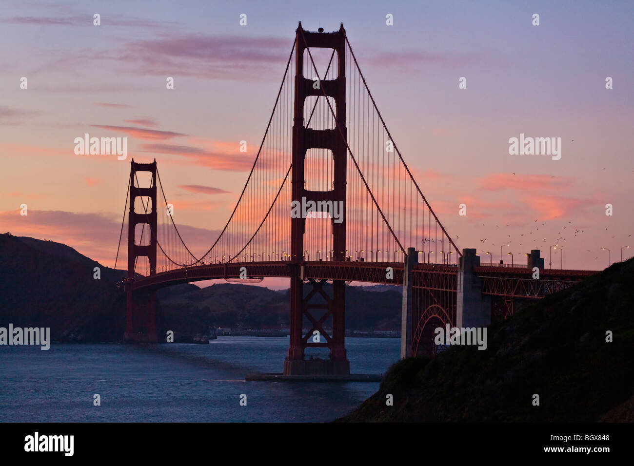 THE GOLDEN GATE BRIDGE at sunset from the cliffs above BAKER BEACH