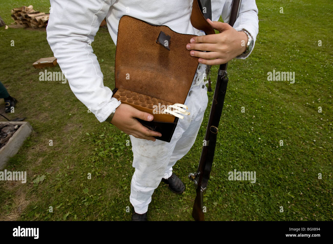 War of 1812 reenactor displaying a replica of a musket cartridge box used during the war. Stock Photo