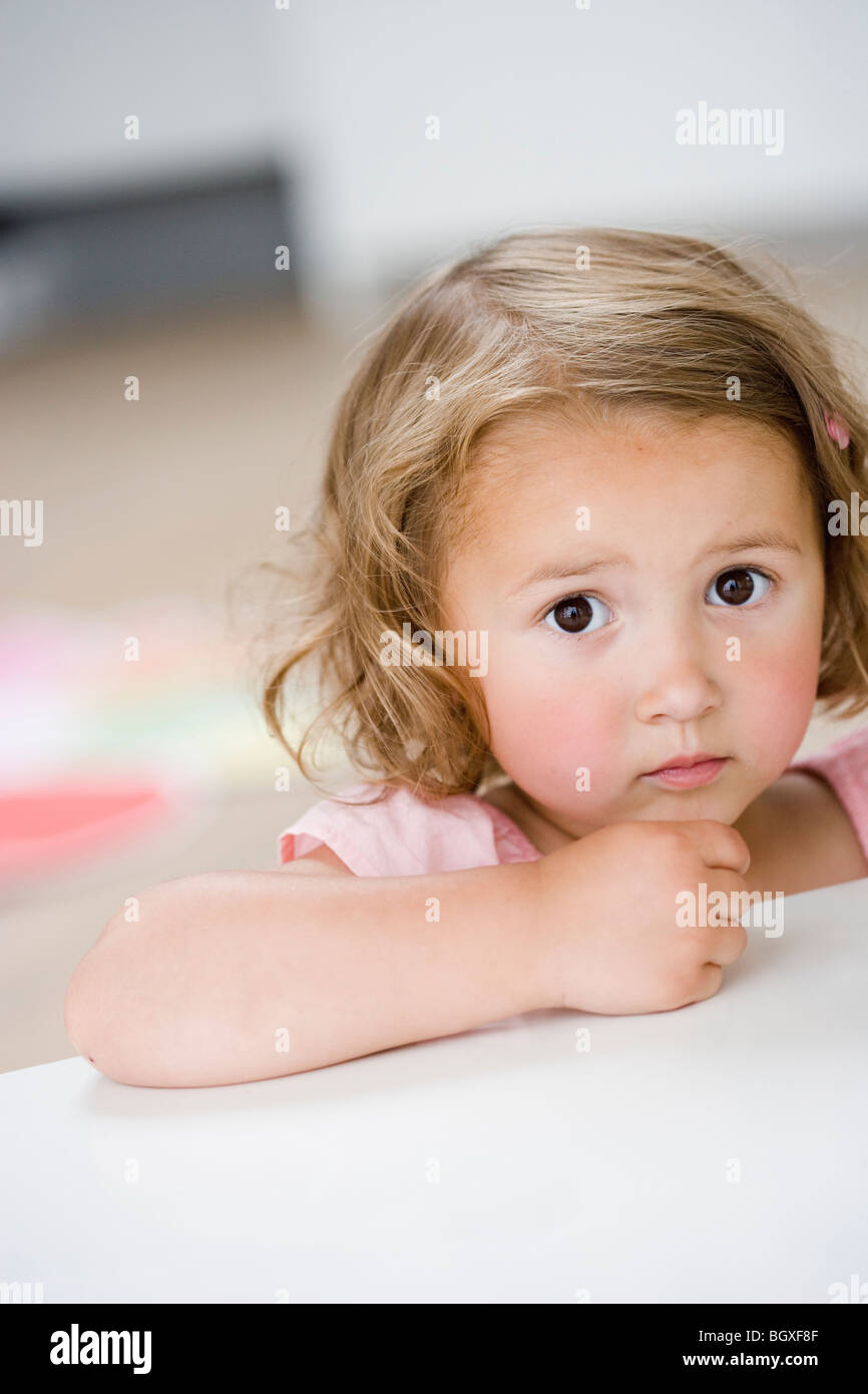 young girl frowning at viewer Stock Photo