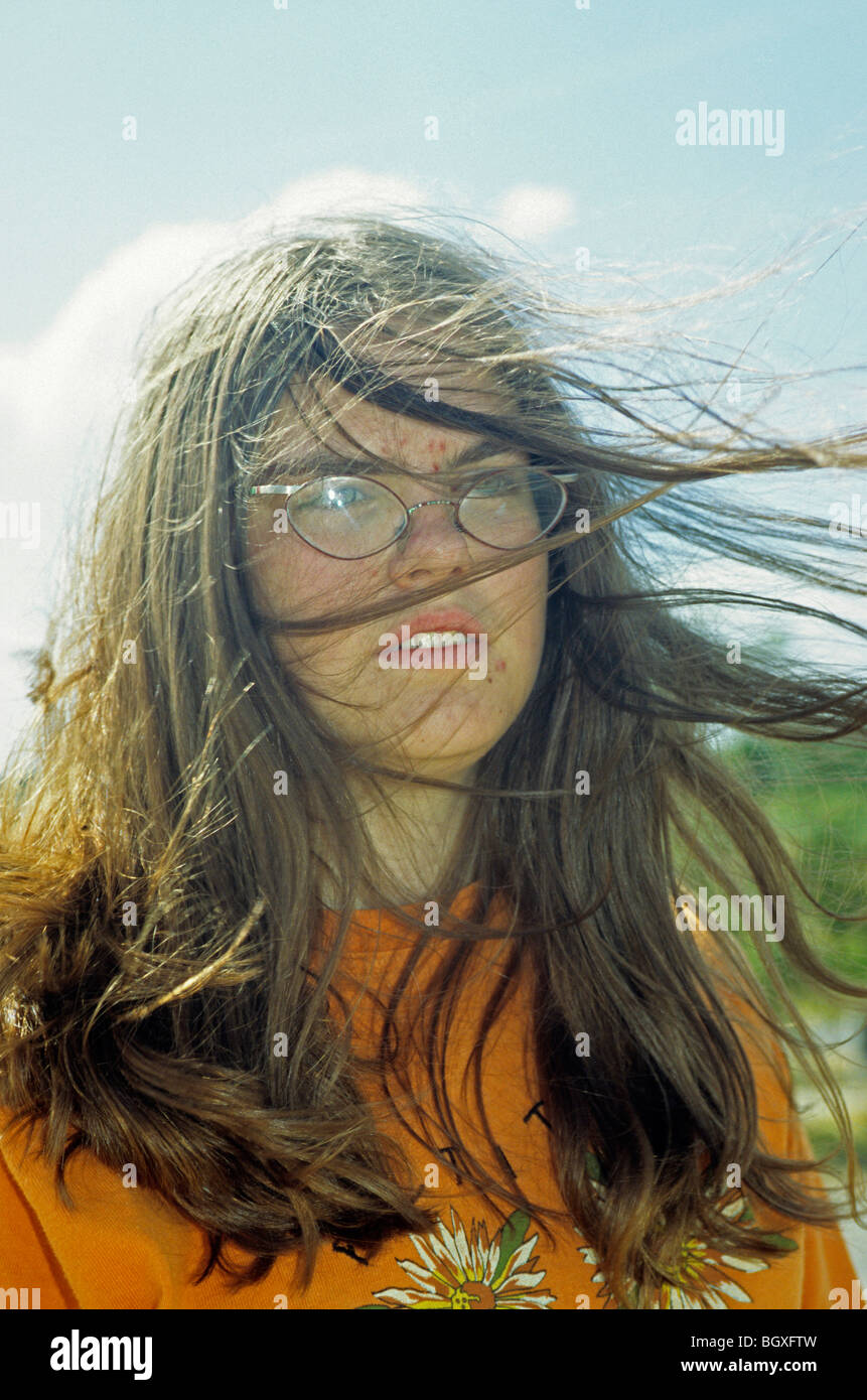 portrait of a young girl whose hair is blowing in the wind Stock Photo